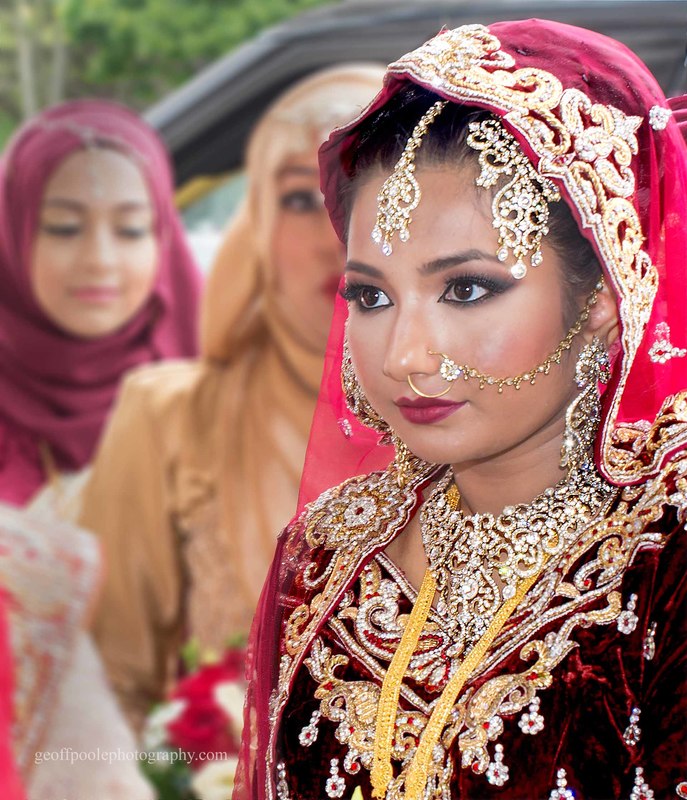 A beautiful Indian bride, showing little emotion.